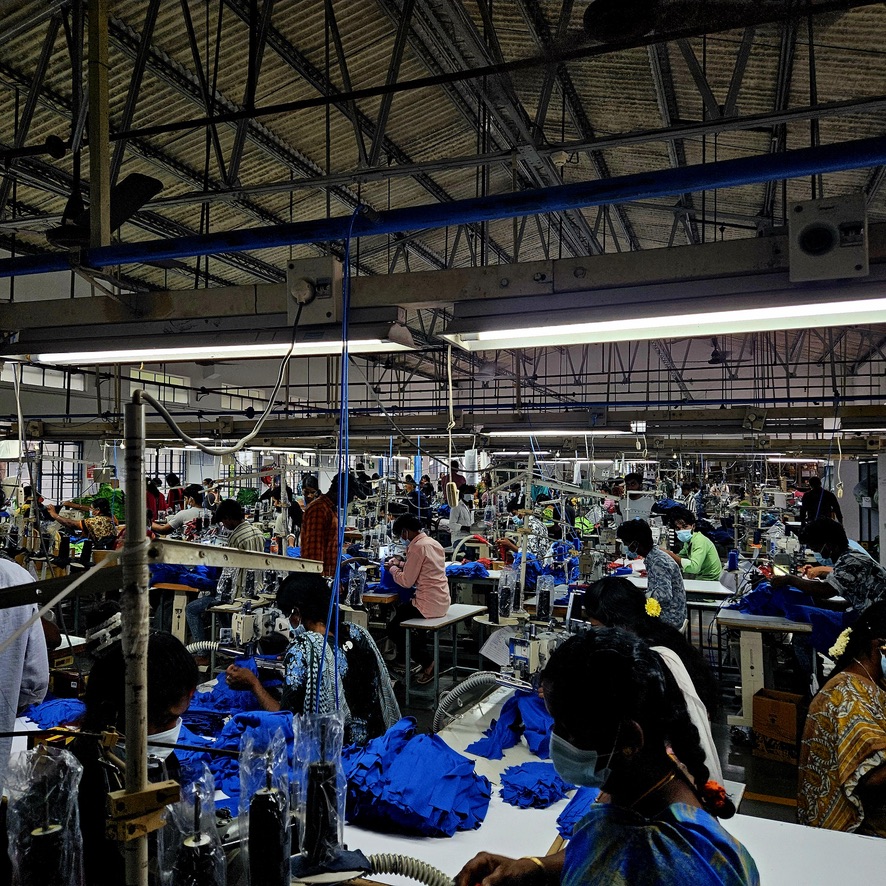 Production floor with workers sewing garments