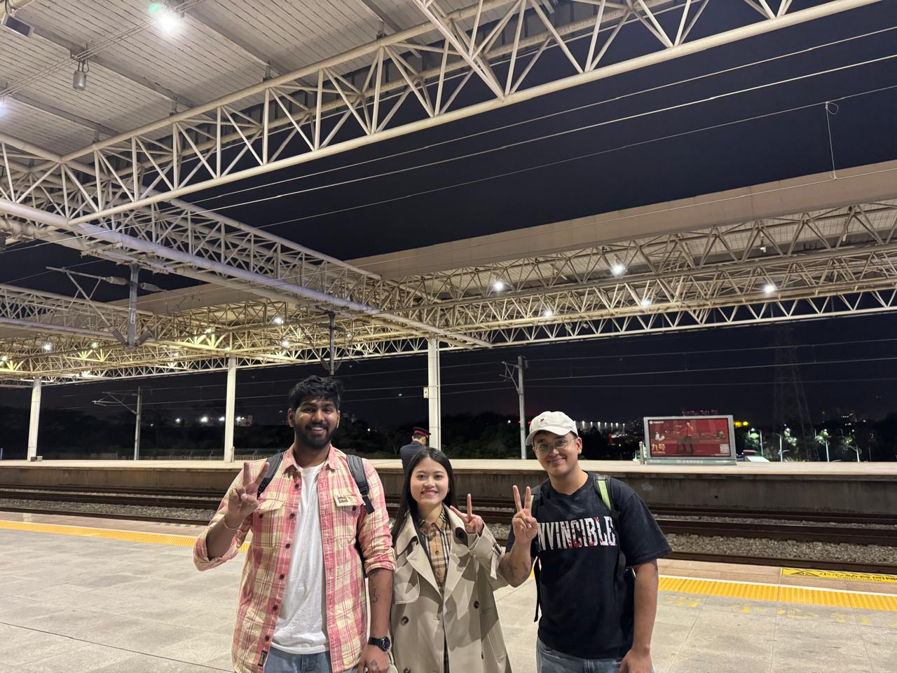Team photo at train station during factory visit